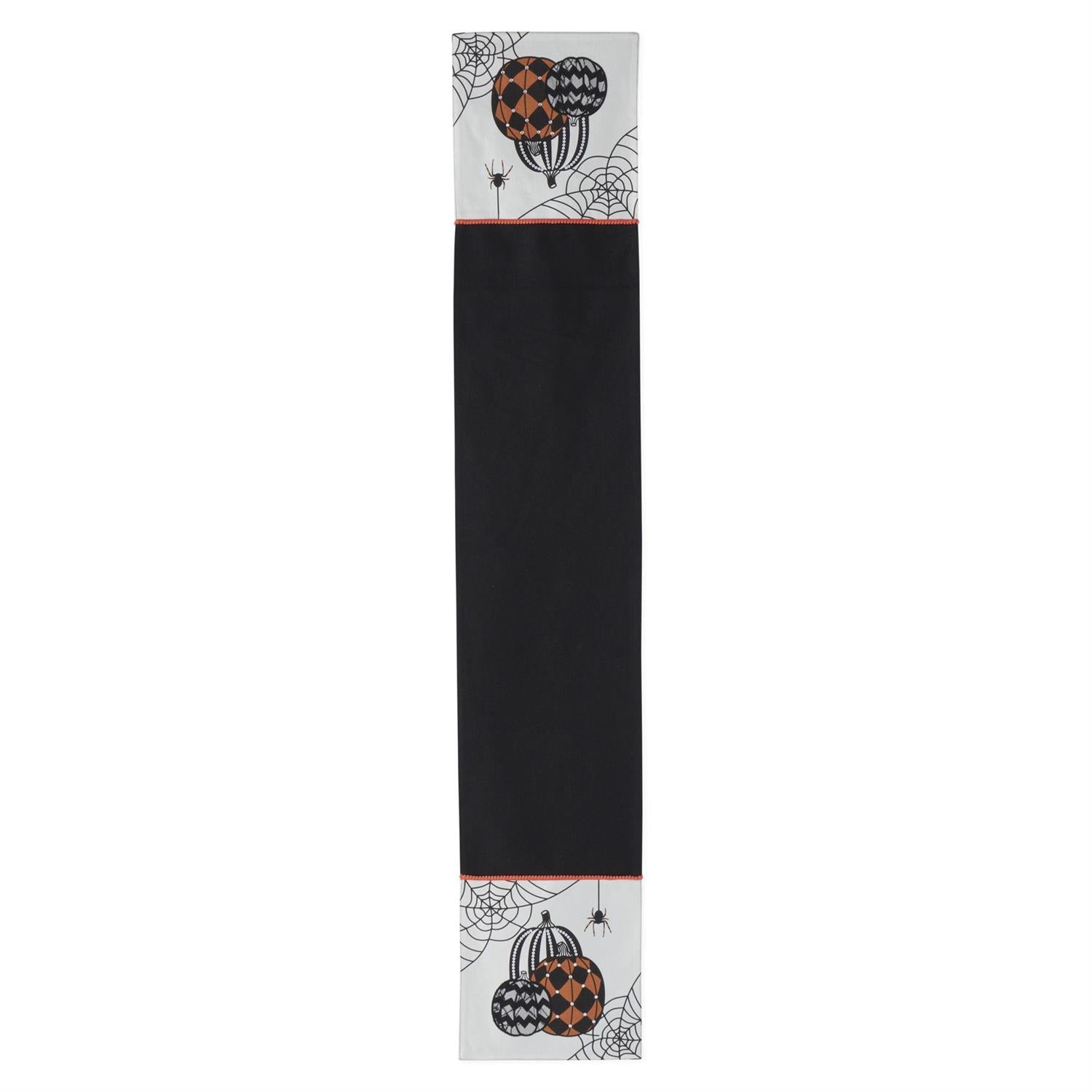 Halloween-themed table runner with pumpkins and cobwebs on a black background
