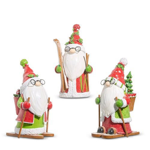 Set of three decorative Santa Claus figures with winter accessories on a white background