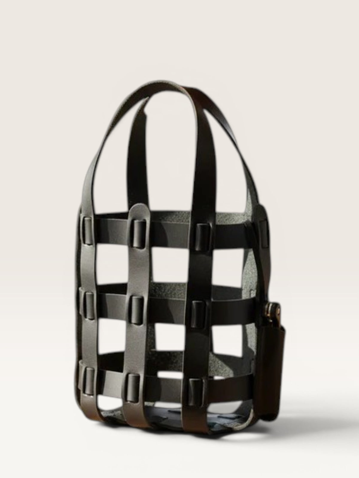 Black cage-style handbag on a light gray background