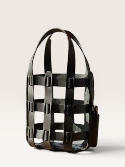 Black cage-style handbag on a light gray background