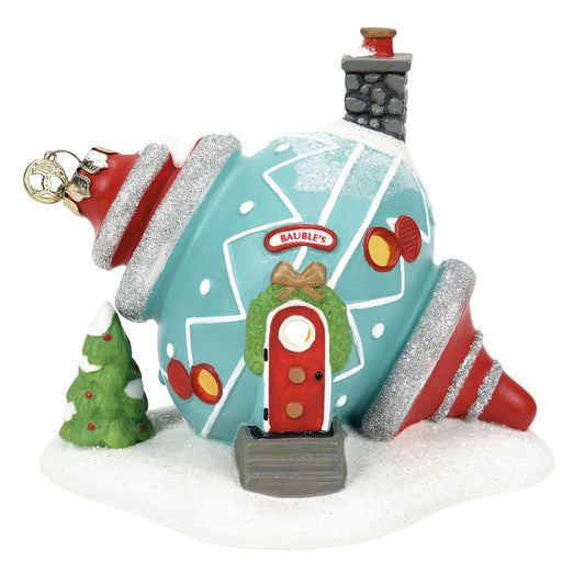 Christmas-themed ornament resembling a house with a chimney and tree on a white background