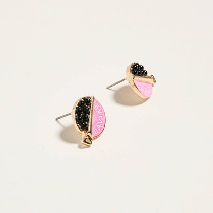 Pair of earrings with pink and black design on a light beige background