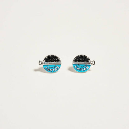 Pair of earrings with blue and black stones and 'Caviar' text on a white background