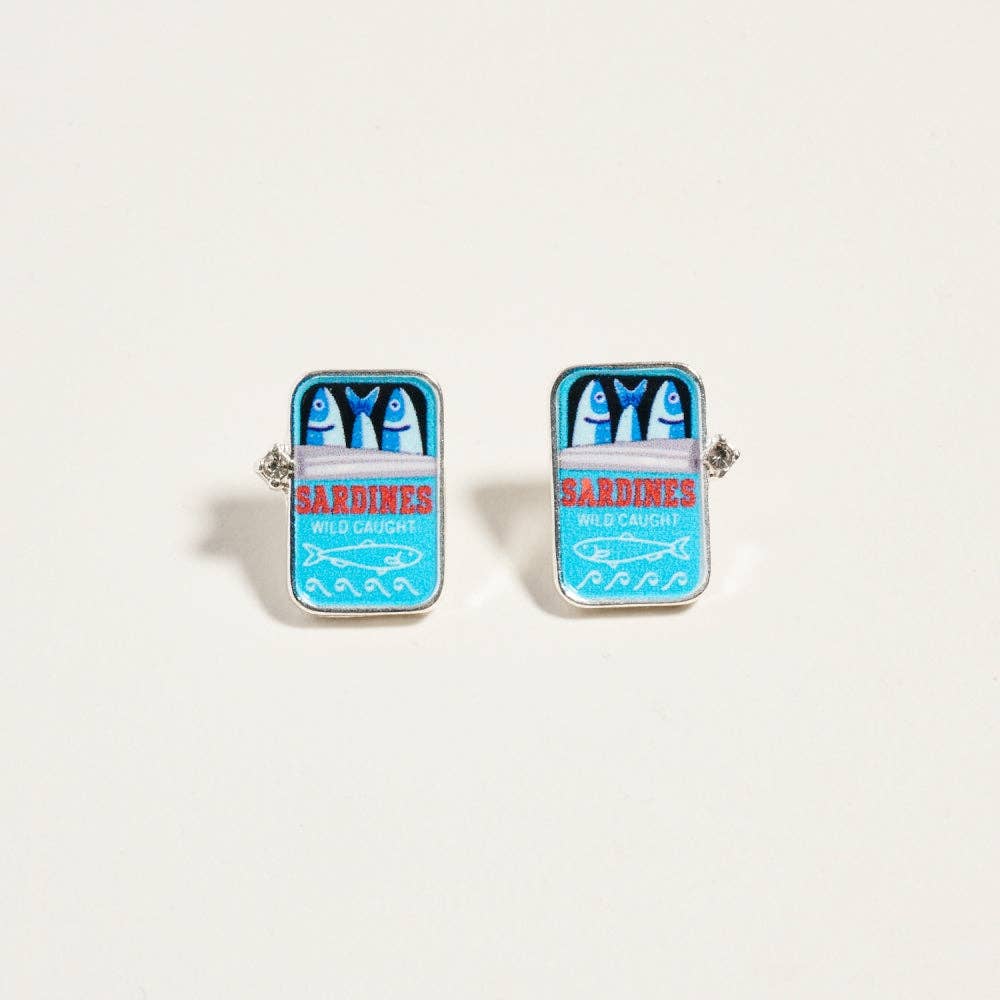 Cufflinks designed like a can of sardines on a light beige background