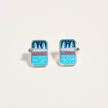 Cufflinks designed like a can of sardines on a light beige background