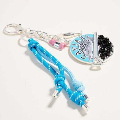 Blue braided keychain with a heart-shaped tag on a white background