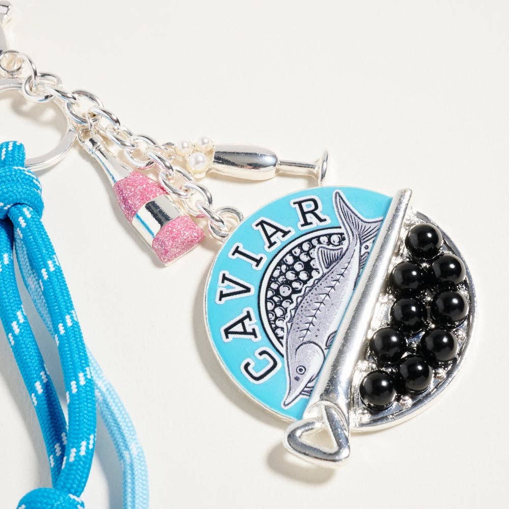 Keychain with 'Caviar' theme featuring a blue pendant, black beads, and a blue lanyard on a white background.