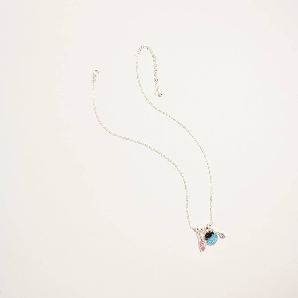 Silver chain necklace with turquoise blue caviar tin and champagne bottle charms for coastal luxe vacation style