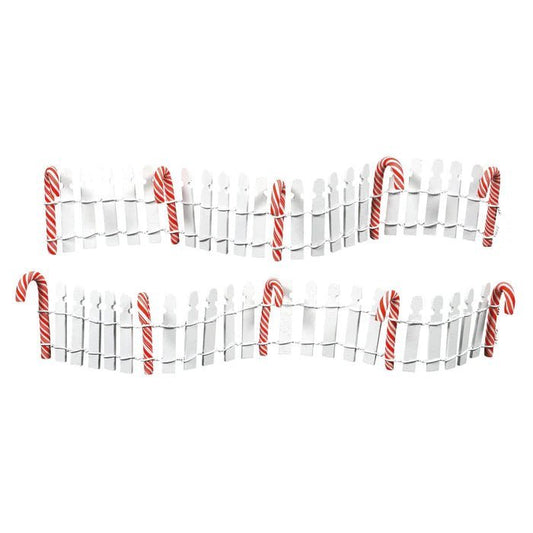 Decorative white picket fence with candy cane sticks on a white background