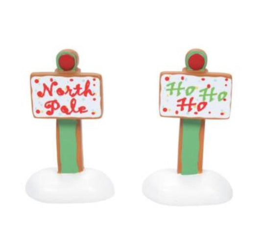 Two gingerbread sign figurines with 'North Pole' and 'Ho Ho Ho' text on a white background.