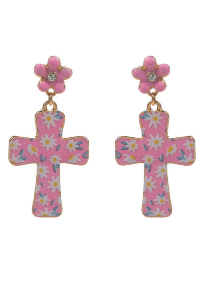 Pink cross-shaped earrings with floral designs on a white background