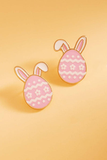 Pink bunny ears earrings on a yellow background