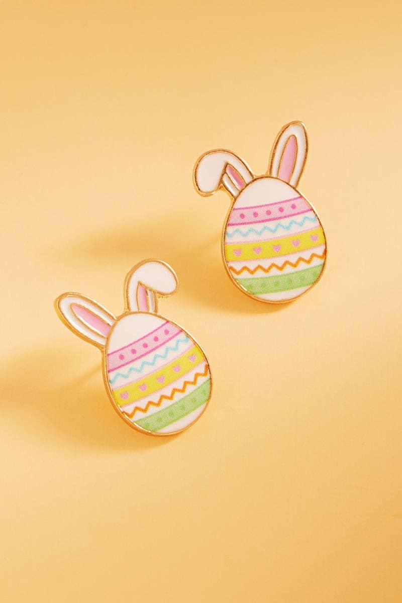 Easter egg-shaped earrings with bunny ears on a yellow background