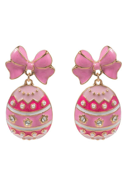 Pink egg-shaped earrings with bow details on a white background