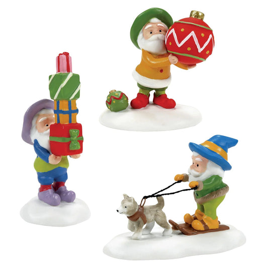 Set of three colorful Christmas-themed gnome figurines on a white background