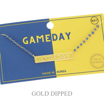 Gold 'GAMEDAY' necklace on a blue and yellow card with 'GAMEDAY' text.