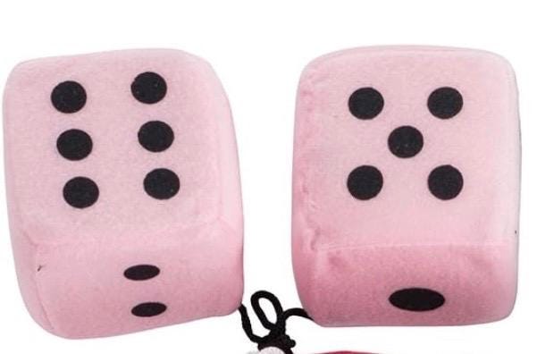 Two pink dice-shaped cushions with black dots on a white background