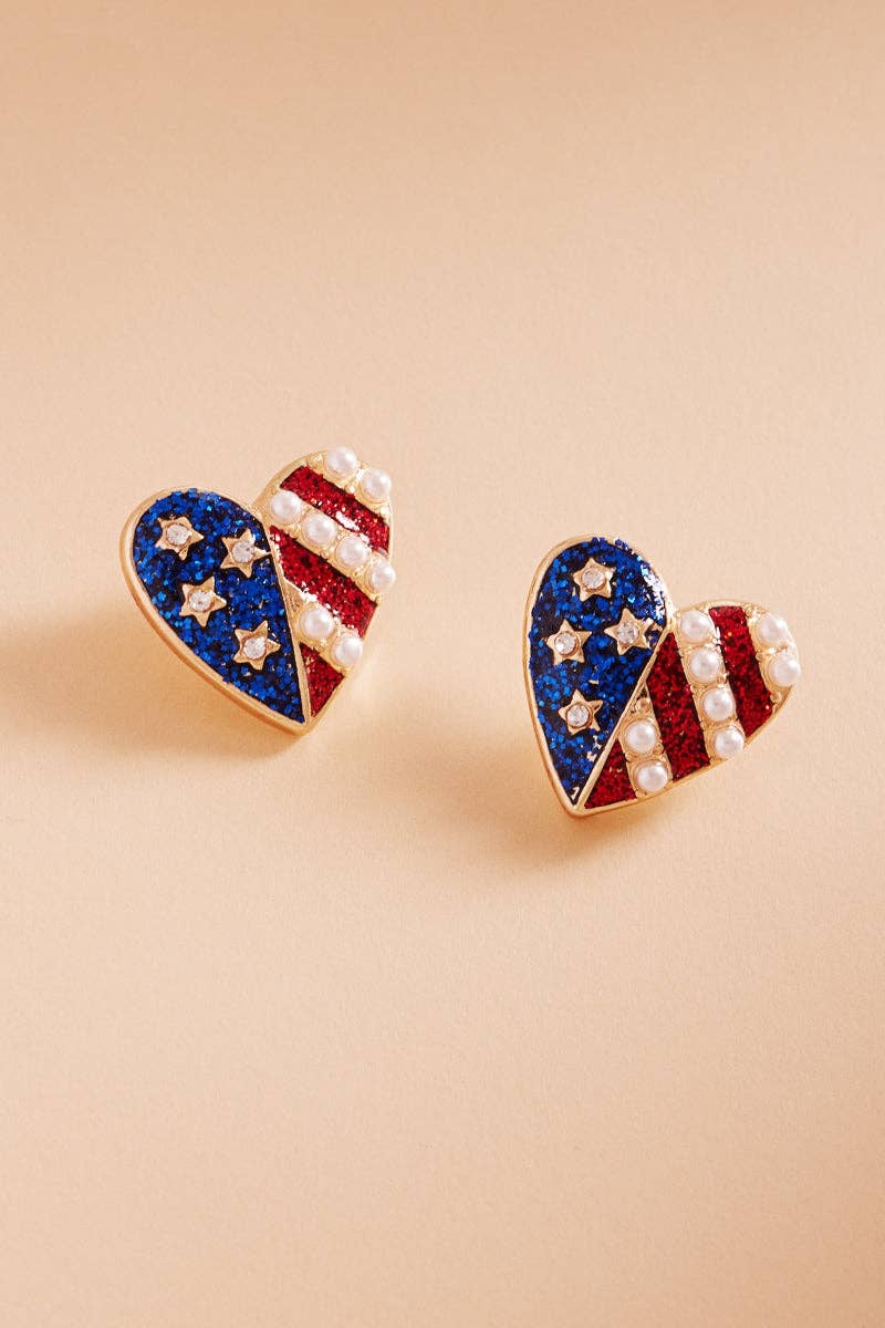 Heart-shaped earrings with American flag design on a beige background