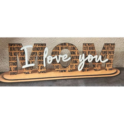 Wooden decorative sign with 'I love you' text on a neutral background