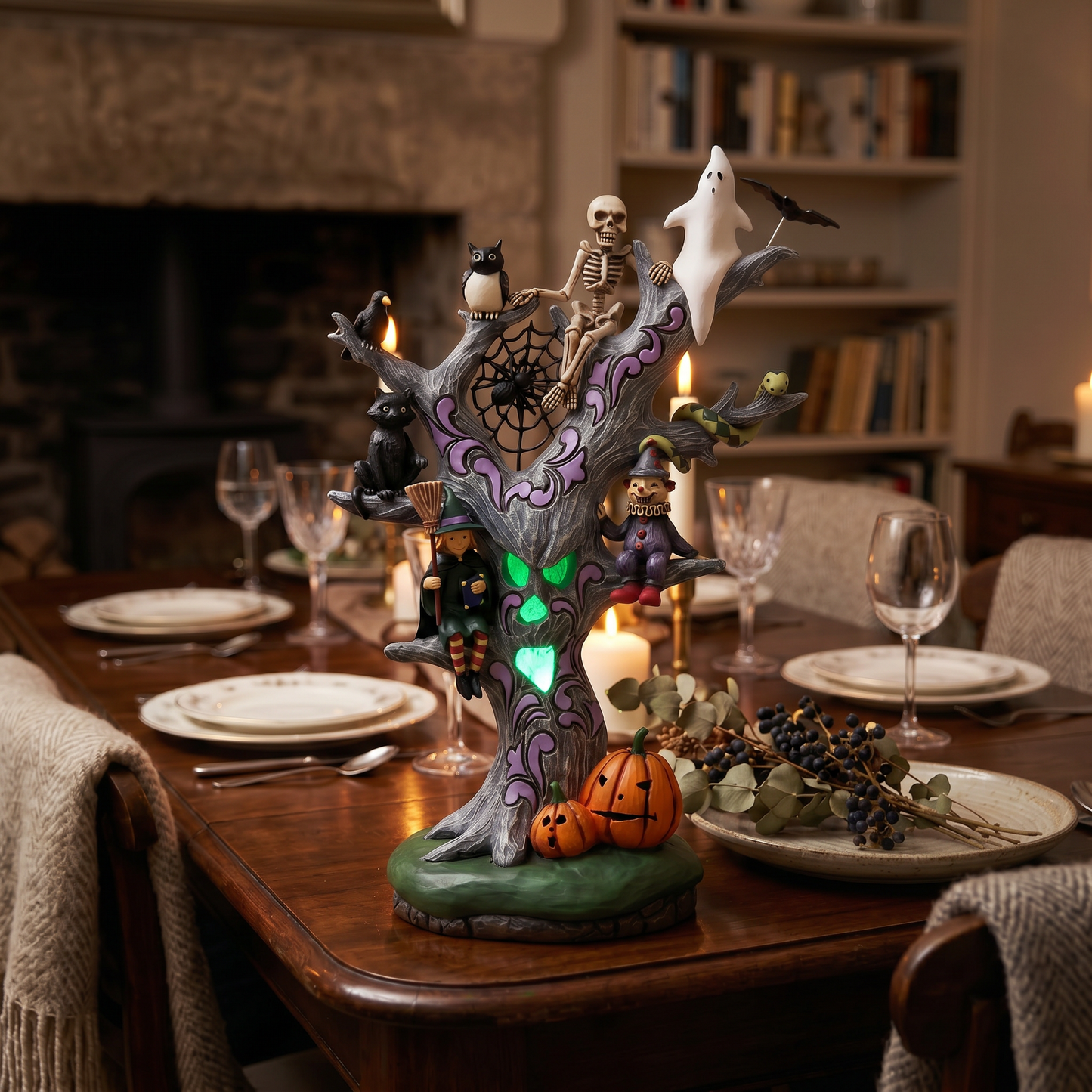 Halloween-themed decorative tree on a dining table with candles and plates.