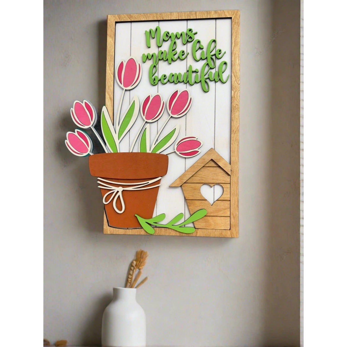 Decorative wall art (16x24) with flowers and text on a wooden frame, mounted on a wall.
