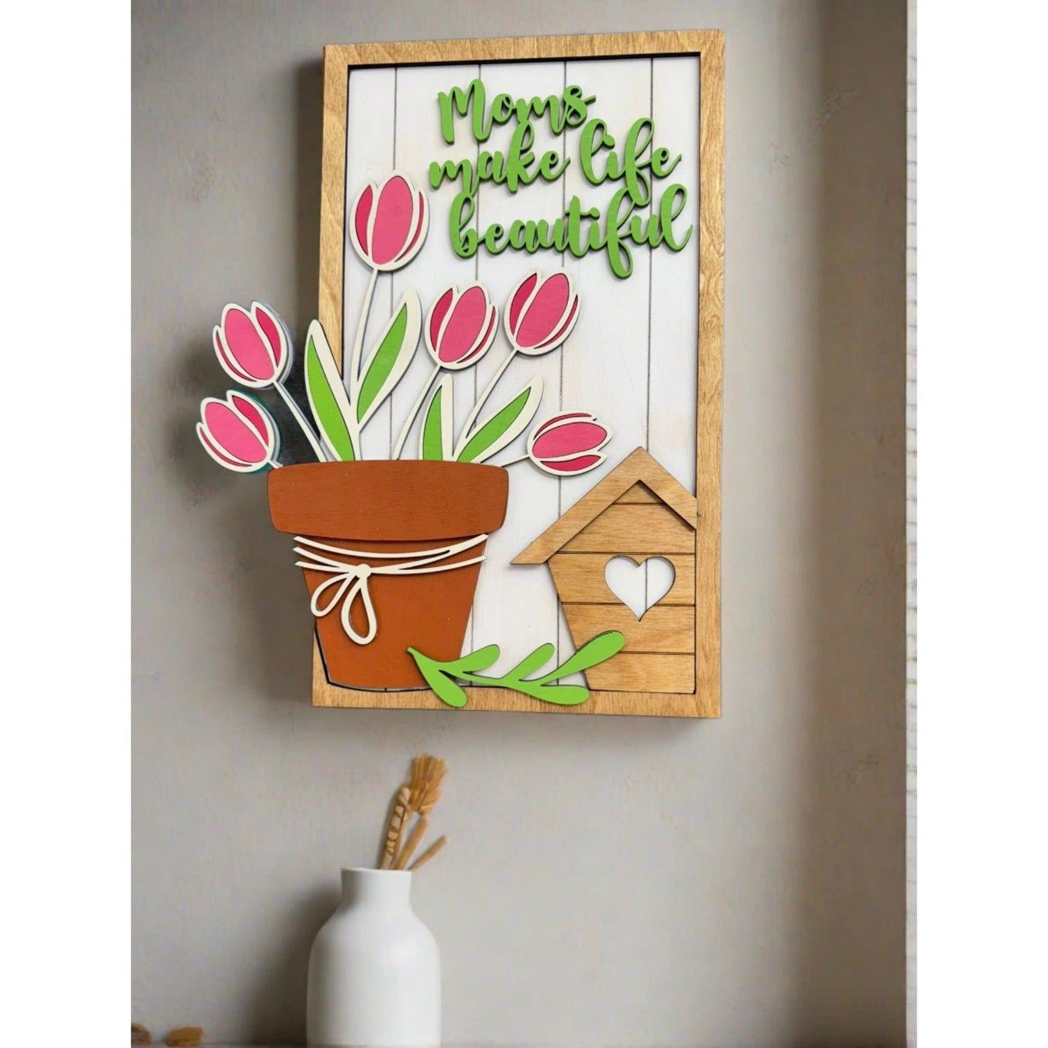 Decorative wall art (16x24) with flowers and text on a wooden frame, mounted on a wall.