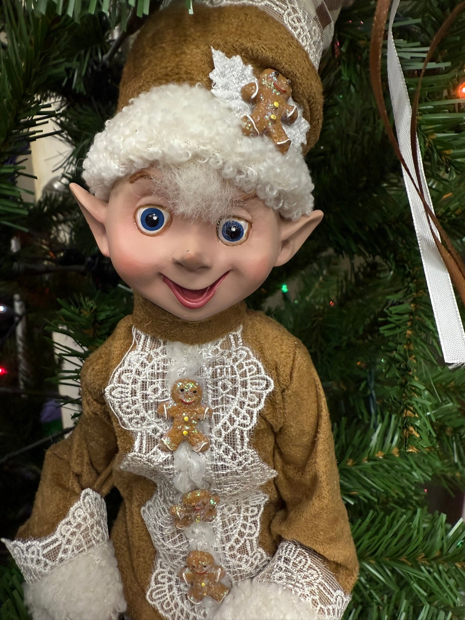 Elf figurine with gingerbread decorations on a Christmas tree