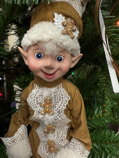 Elf figurine with gingerbread decorations on a Christmas tree