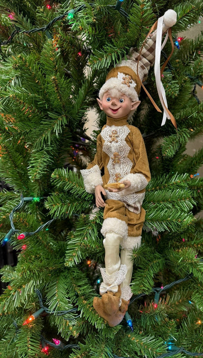 Elf ornament on a decorated Christmas tree with lights and ornaments