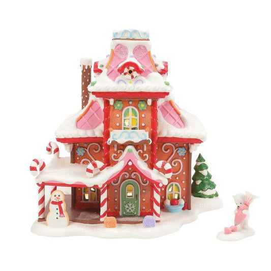 Decorative gingerbread house with candy cane details on a white background