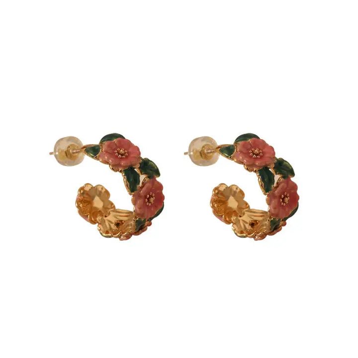 Pair of floral hoop earrings on a white background