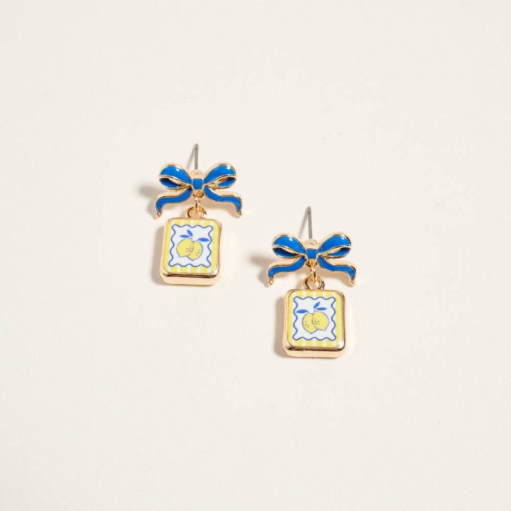 Pair of earrings with blue bows and square designs on a light gray background
