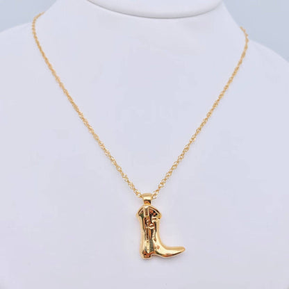 Gold cowboy boot necklace on a mannequin with a white background