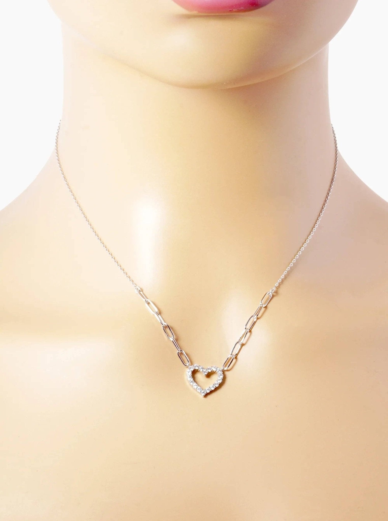 Silver necklace with a heart pendant on a mannequin